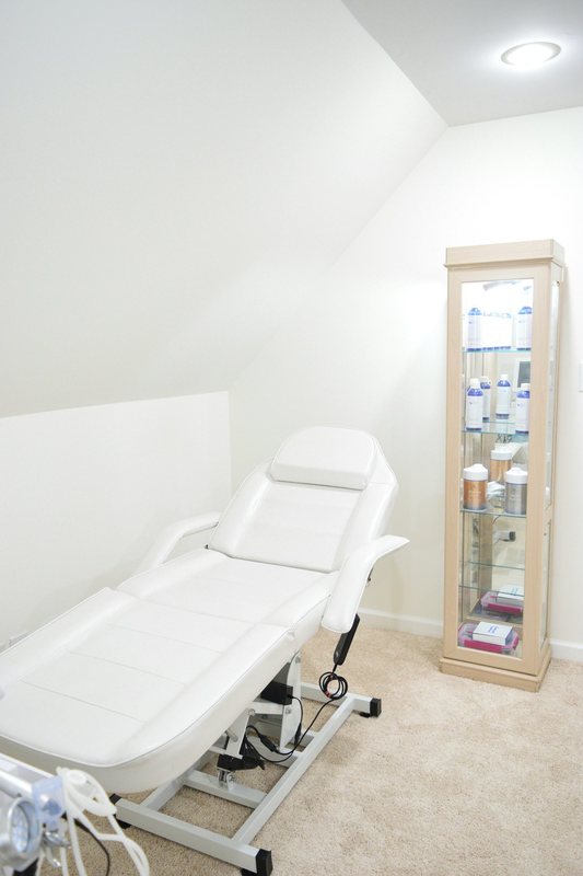 The treatment room, the treatment chair and the glass product cabinet.