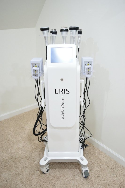 A body contouring machine on a trolley in the treatment room.