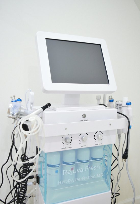 A facial treatment machine on a trolley in the treatment room.