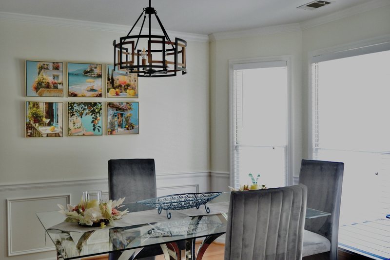 The dining room from the other side, with framed pictures along the wall.