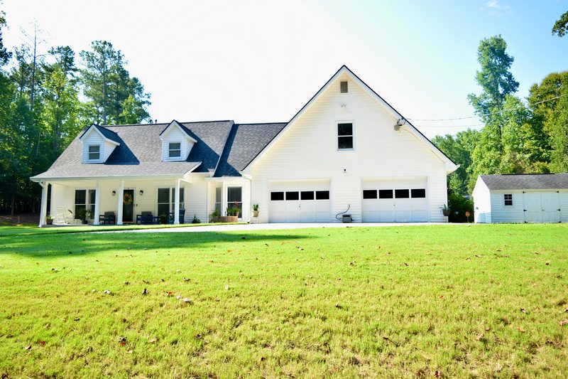 The full width of the property, house, garage wing and garden shed.